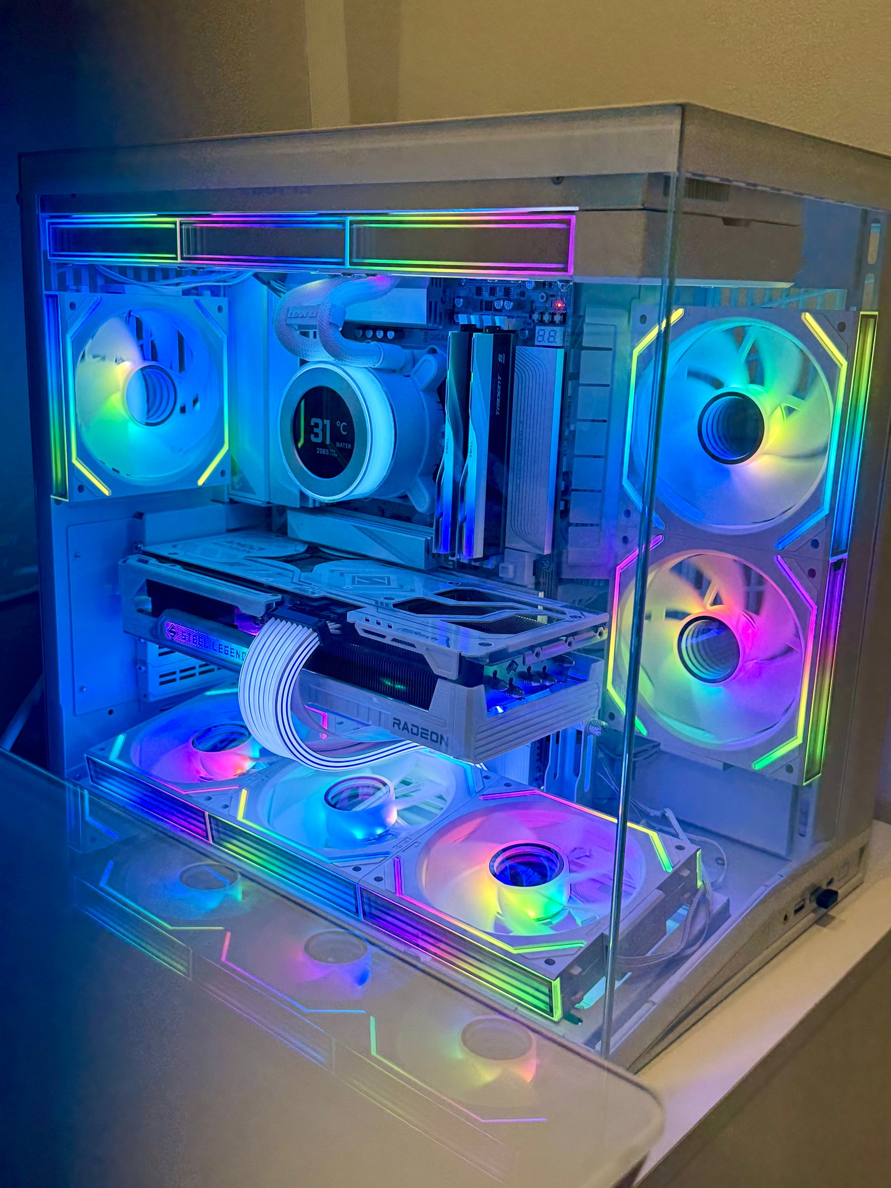A white custom PC build with clean cable routing and RGB fans